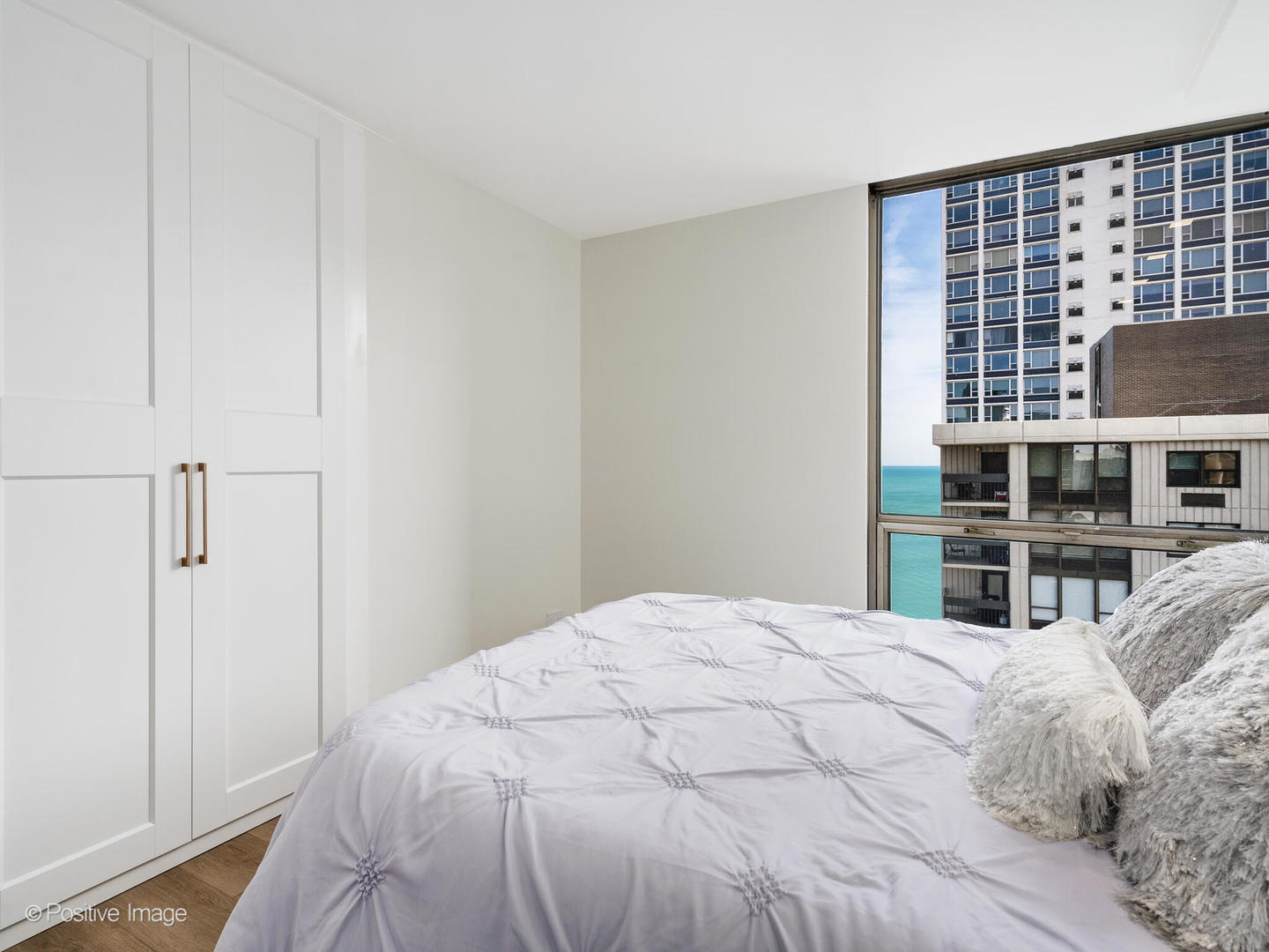 1310 North Ritchie Court, Unit 27C Chicago, IL 60610 - Photo 23 of 30 a bedroom with a bed and a window