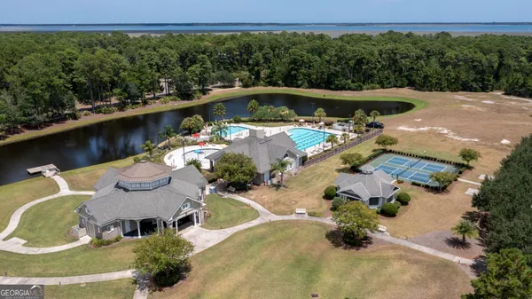 an aerial view of house with swimming pool having outdoor seating