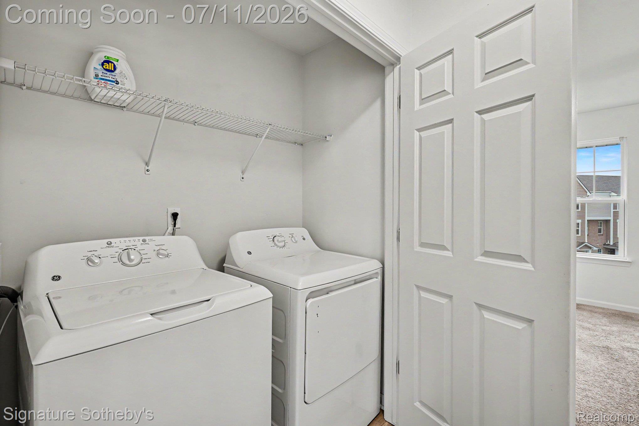 2500 Normandy Road, Unit 40 Royal Oak, MI 48073 - Photo 23 of 26 Dedicated laundry area featuring a white wire shelf, light wall paint, and wood-finish flooring