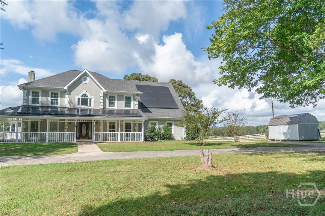 1963 Rehoboth Road Bowman, GA 30624 - Photo 2 of 64 Front of house with parking pad and shed.