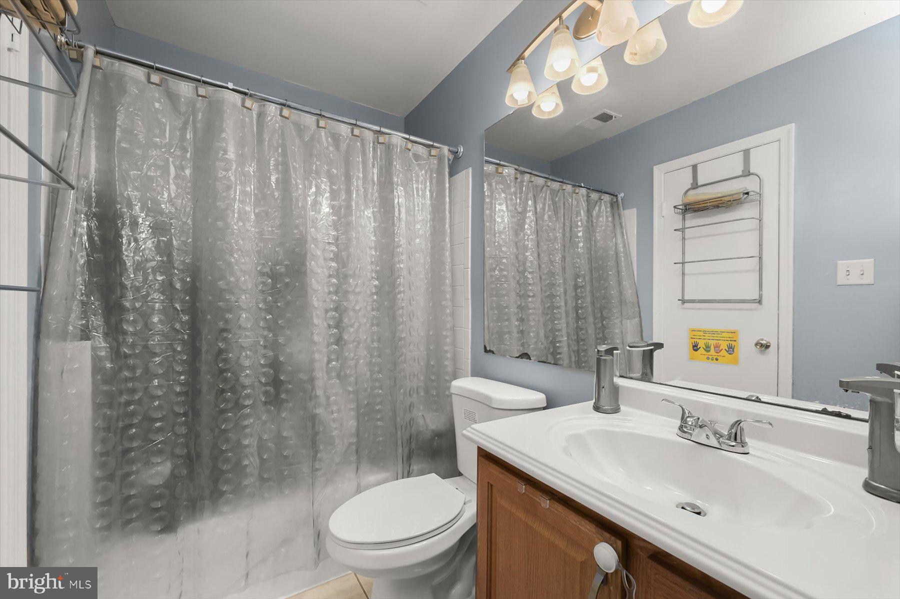 737 St Michaels Drive Bowie, MD 20721 - Photo 34 of 41 a bathroom with a sink a toilet a mirror and shower curtain