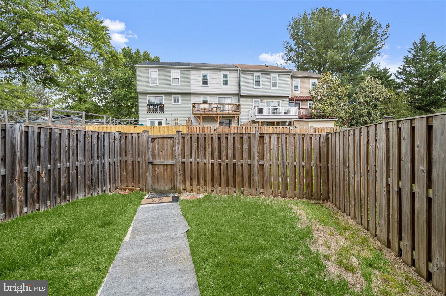 737 St Michaels Drive Bowie, MD 20721 - Photo 40 of 41 a view of a house with a small yard and wooden fence