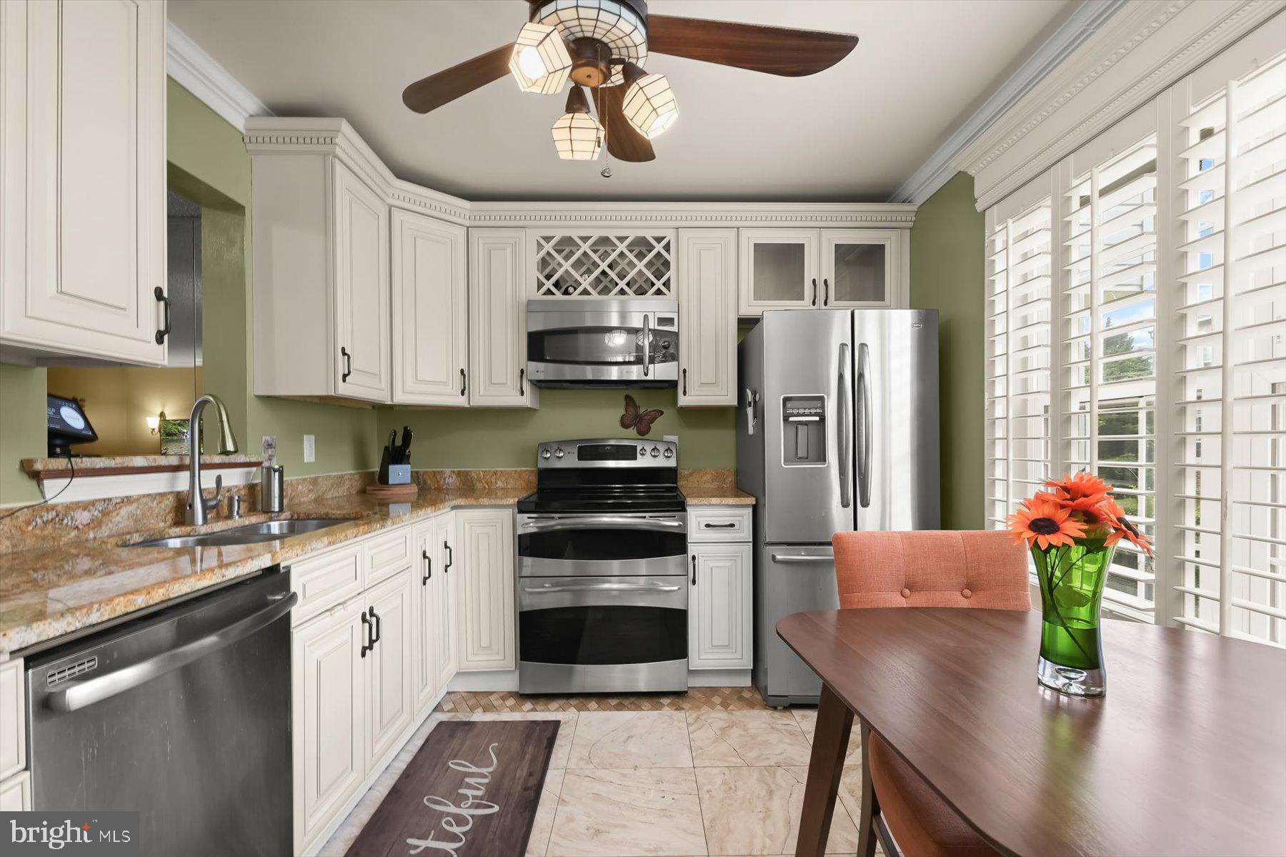 737 St Michaels Drive Bowie, MD 20721 - Photo 6 of 41 a kitchen with stainless steel appliances a stove refrigerator sink and cabinets