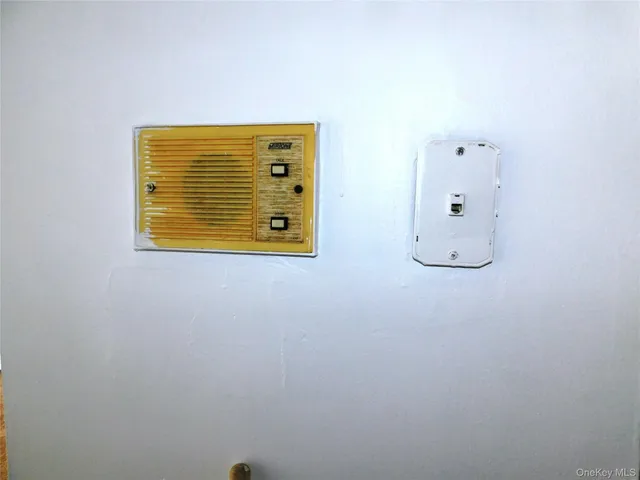 a utility room with stainless steel appliances wooden cabinets and stove top oven