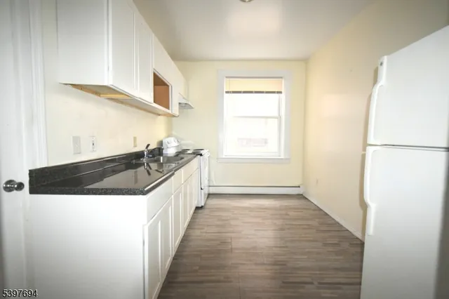 a kitchen with a sink a stove and a refrigerator