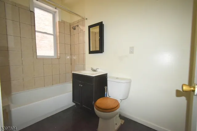a bathroom with a sink a toilet and bathtub