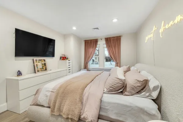 a bedroom with a bed and a flat screen tv