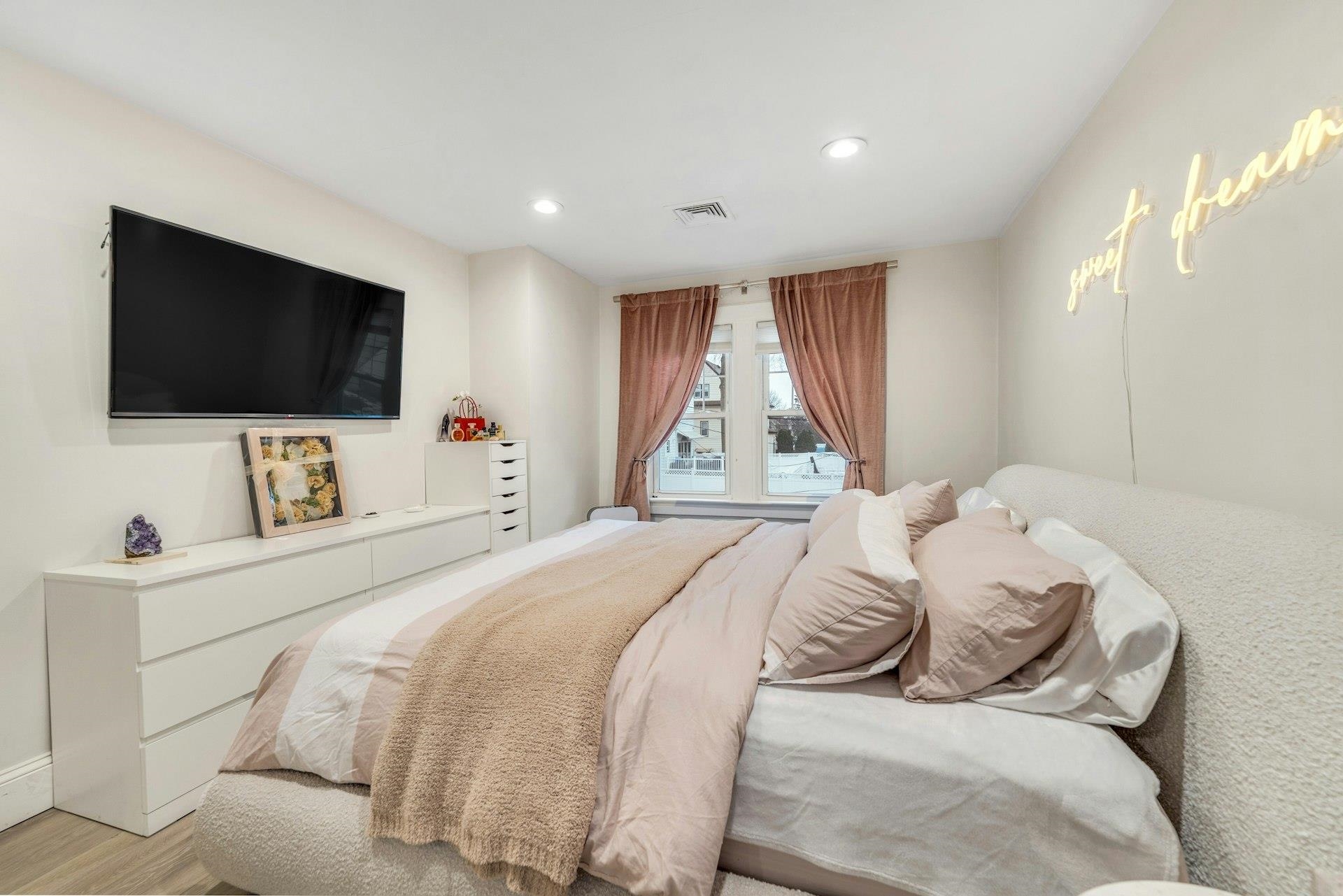 67 Hillcrest Road Kearny, NJ 07032 - Photo 13 of 30 a bedroom with a bed and a flat screen tv