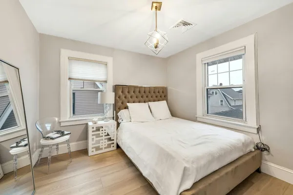 a bedroom with a large bed and a window