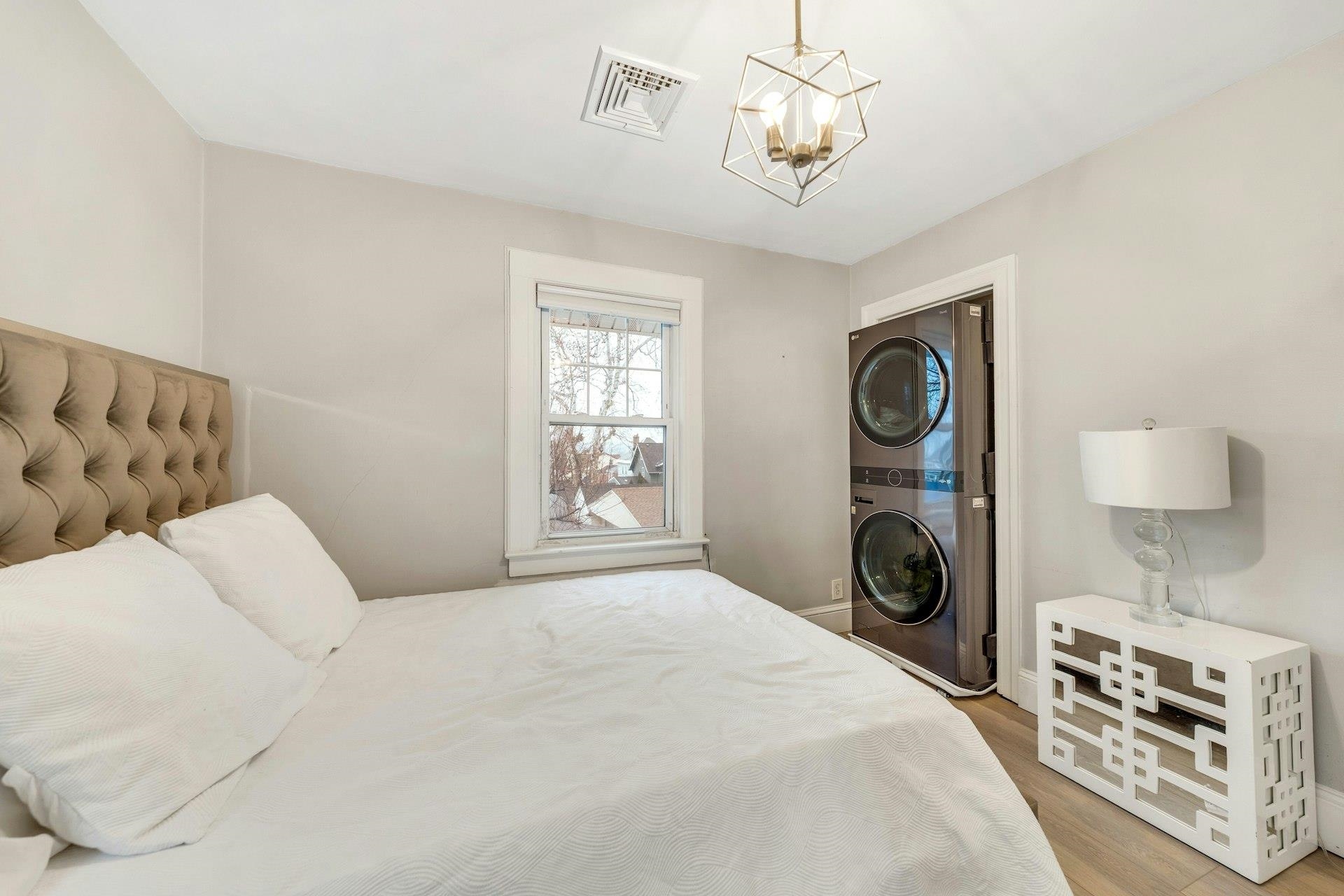67 Hillcrest Road Kearny, NJ 07032 - Photo 16 of 30 a spacious bedroom with a bed and a chandelier