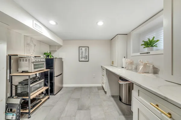 a living room with furniture a couch and potted plant