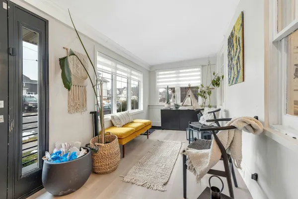 a living room with furniture and floor to ceiling windows