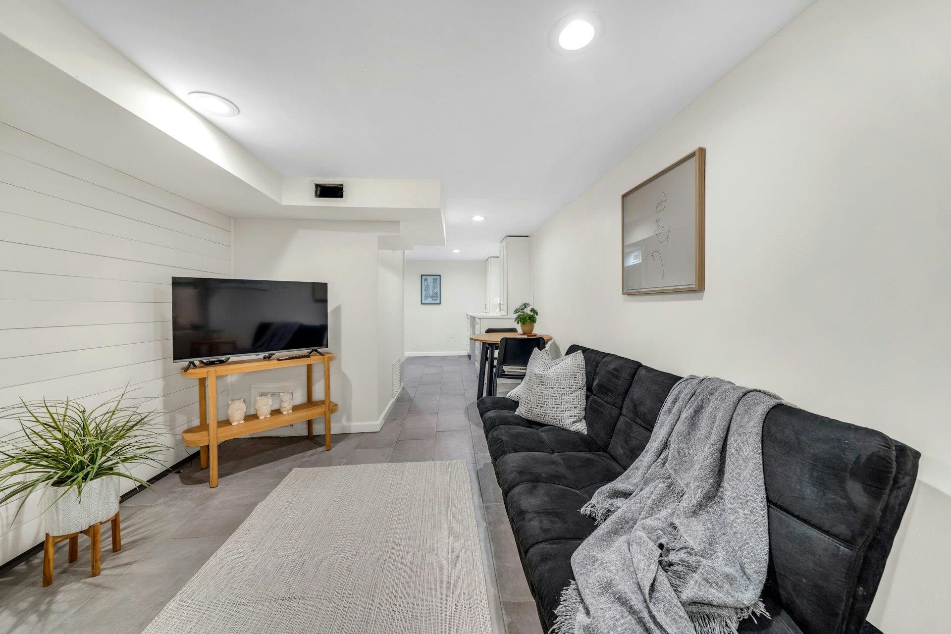 67 Hillcrest Road Kearny, NJ 07032 - Photo 23 of 30 a living room with furniture and a flat screen tv