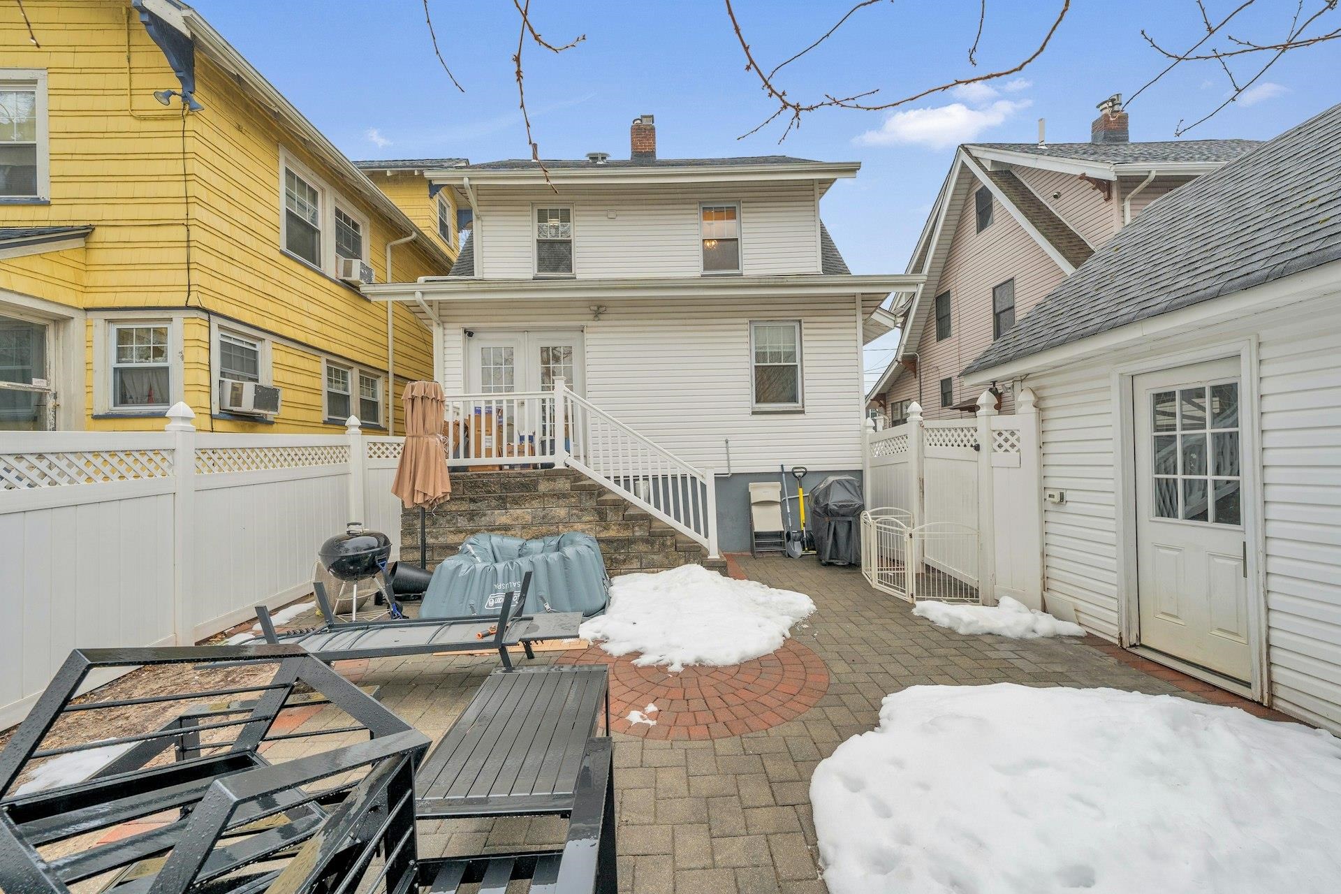 67 Hillcrest Road Kearny, NJ 07032 - Photo 29 of 30 a view of a patio with table and chairs with wooden fence