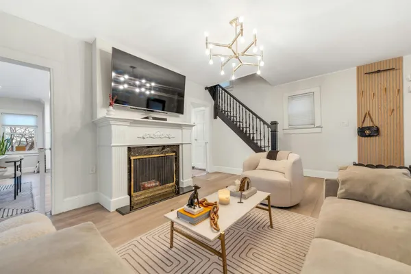 a living room with furniture a flat screen tv and a fireplace