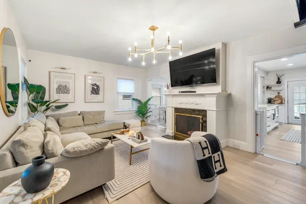 a living room with furniture a flat screen tv and a fireplace