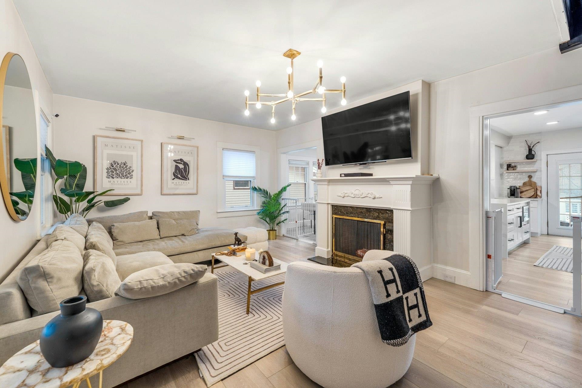 67 Hillcrest Road Kearny, NJ 07032 - Photo 5 of 30 a living room with furniture a flat screen tv and a fireplace