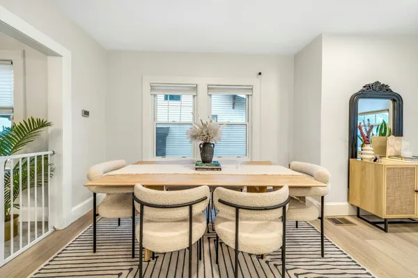 a view of a dining room with furniture and wooden floor