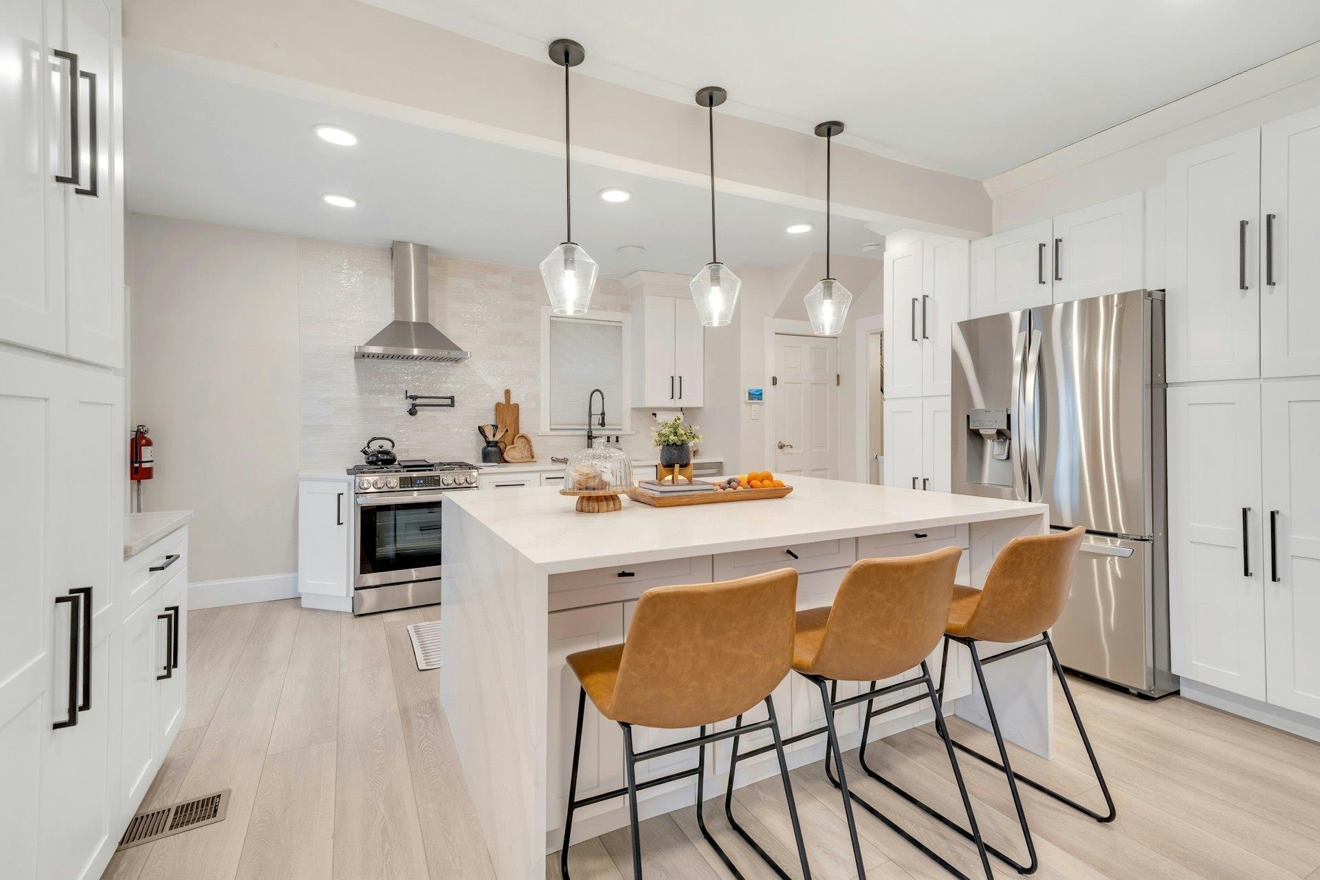 67 Hillcrest Road Kearny, NJ 07032 - Photo 8 of 30 a kitchen with stainless steel appliances kitchen island refrigerator stove and white cabinets