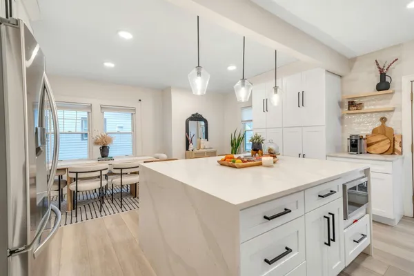 a view of kitchen island with furniture and wooden floor