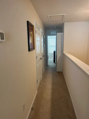 a view of a hallway with wooden shelves