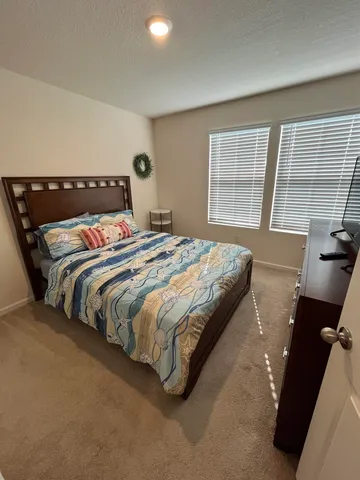 a bedroom with bed and window