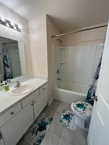 a bathroom with a sink mirror toilet and bathtub