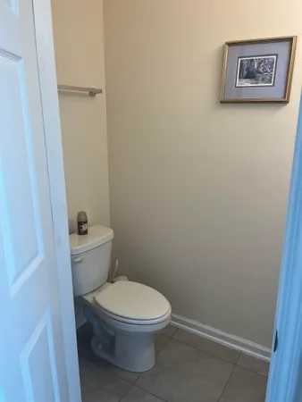 a white toilet sitting next to a shower