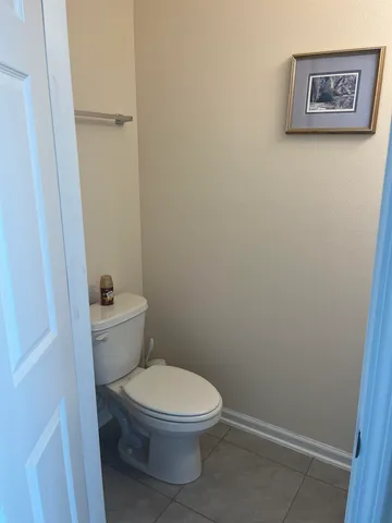 a white toilet sitting next to a shower