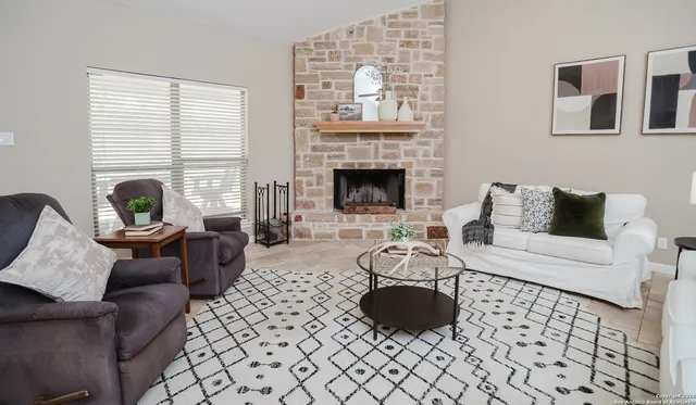 a living room with furniture and a fireplace
