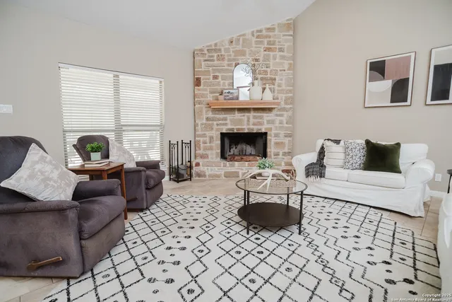 a living room with furniture and a fireplace