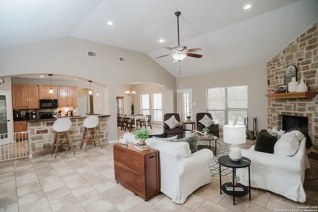 a living room with fireplace furniture and a chandelier