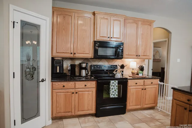 a kitchen with stainless steel appliances granite countertop a stove and a refrigerator