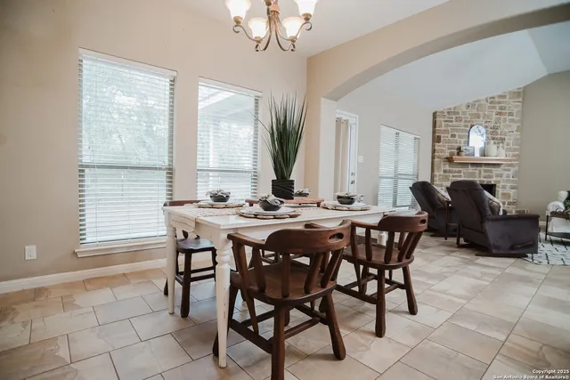 a view of a dining room with furniture and a large window