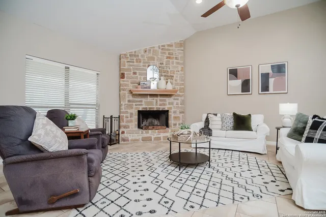 a living room with furniture and a fireplace
