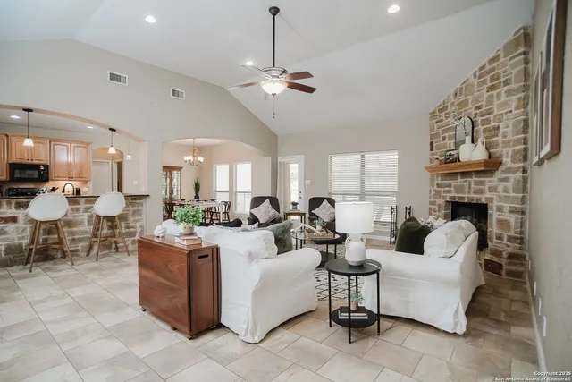 a living room with fireplace furniture and a chandelier