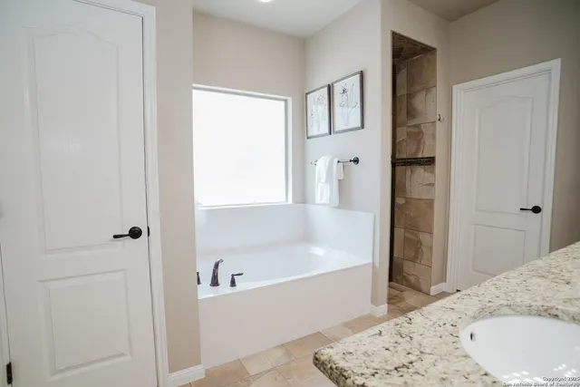 a bathroom with a bathtub and a shower