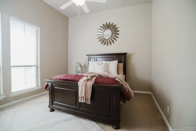 a bed sitting in a bedroom next to a window