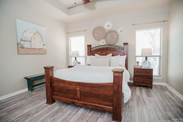 a bedroom with bed and wooden floor