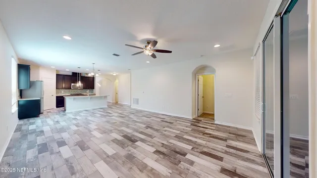 a view of a kitchen with a sink and a refrigerator