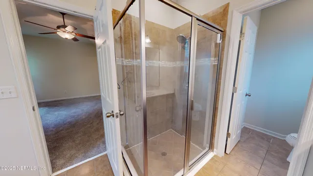 a bathroom with a glass shower door and a mirror