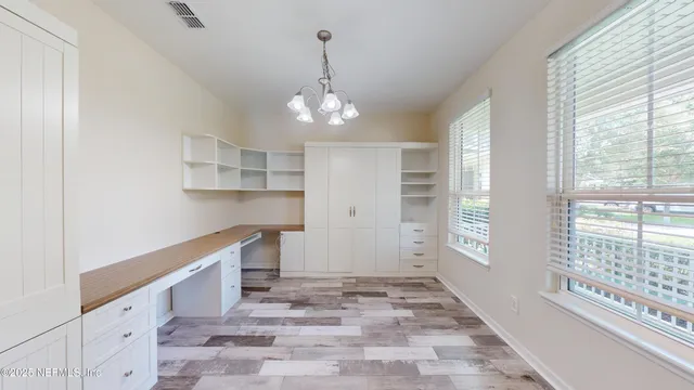 a view of a kitchen with a sink and windows