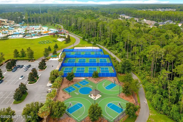 an aerial view of residential houses with outdoor space and swimming pool