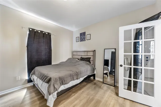 a bedroom with a bed and a window