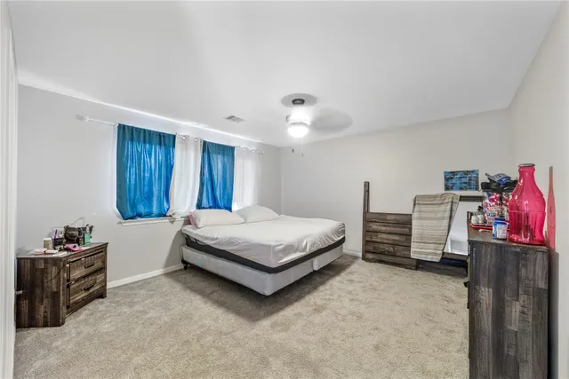 a bedroom with a bed and a view of bedroom