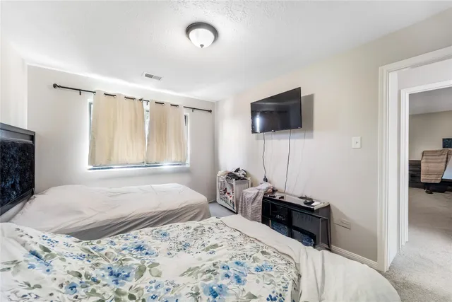 a bedroom with a bed and a television