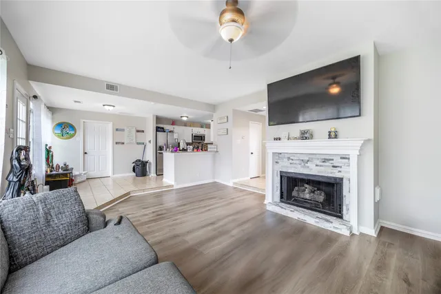 a living room with furniture a flat screen tv and a fireplace