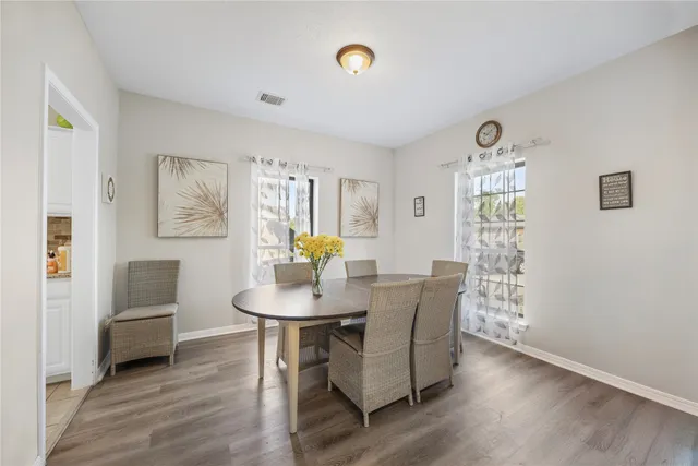 a view of a dining room with furniture and wooden floor