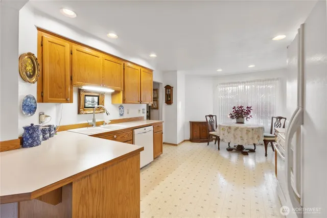 a living room with furniture and a dining table with kitchen view