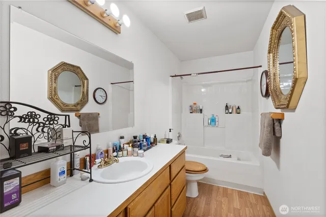 a bathroom with a sink a toilet and a mirror